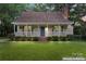 Charming home featuring inviting porch, well-maintained lawn and cozy curb appeal at 6706 Farrington Ln, Charlotte, NC 28227