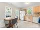 Bright eat-in kitchen with natural light, tile floor, and white appliances at 6706 Farrington Ln, Charlotte, NC 28227