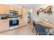 Charming kitchen with light wood cabinets, modern appliances, and a cozy dining area at 6706 Farrington Ln, Charlotte, NC 28227