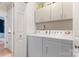 Laundry room features a washer, dryer, white cabinets for storage at 6706 Farrington Ln, Charlotte, NC 28227