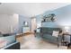 Inviting living room with blue walls, bookshelf, comfortable seating and neutral-toned rug at 6706 Farrington Ln, Charlotte, NC 28227