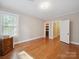 Bedroom with hardwood floors and a view into an adjacent walk-in closet at 729 Montgomery Ave, Albemarle, NC 28001