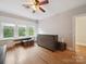 Bright bedroom with hardwood floors, ceiling fan, large windows, and built-in shelving at 729 Montgomery Ave, Albemarle, NC 28001
