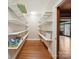 Organized pantry with shelving, hardwood floors, and easy access to the kitchen at 729 Montgomery Ave, Albemarle, NC 28001