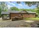 The backyard features a brick barbecue, a patio and a screened-in porch at 7613 Happy Hollow Dr, Mint Hill, NC 28227