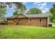 The backyard features a lush lawn and a brick exterior of the home at 7613 Happy Hollow Dr, Mint Hill, NC 28227
