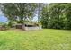 The large backyard has plenty of trees and a storage shed at 7613 Happy Hollow Dr, Mint Hill, NC 28227