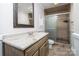Updated bathroom featuring framed mirror, granite vanity, and tiled shower with glass door at 7613 Happy Hollow Dr, Mint Hill, NC 28227