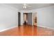Spacious bedroom with wood floors, a ceiling fan, and multiple entryways for easy access at 7613 Happy Hollow Dr, Mint Hill, NC 28227