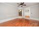 Spacious bonus room with wood floors, and an open floor plan featuring a view to the kitchen at 7613 Happy Hollow Dr, Mint Hill, NC 28227