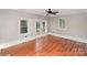 Versatile bonus room with bright windows, wood floors, and outside views at 7613 Happy Hollow Dr, Mint Hill, NC 28227