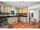 Updated kitchen with stainless steel appliances, granite countertops, and custom cabinetry at 7613 Happy Hollow Dr, Mint Hill, NC 28227