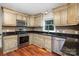 Updated kitchen with stainless steel appliances, granite countertops, and custom cabinetry at 7613 Happy Hollow Dr, Mint Hill, NC 28227