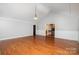 Bright living room with hardwood floors, wainscotting, and view to the kitchen at 7613 Happy Hollow Dr, Mint Hill, NC 28227