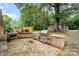 The outdoor brick kitchen has a built in grill and plenty of prep space at 7613 Happy Hollow Dr, Mint Hill, NC 28227