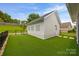 Low maintenance backyard features artificial turf, a black metal fence, and a detached garage at 827 Digby Rd, Rock Hill, SC 29730