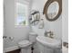 Powder room featuring pedestal sink, and round mirrors with decorative shelves at 827 Digby Rd, Rock Hill, SC 29730