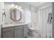 Updated bathroom features a shower over tub and a furniture style vanity with marble counters at 827 Digby Rd, Rock Hill, SC 29730