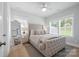 Comfortable bedroom with tufted headboard, soft bedding, and natural light from windows at 827 Digby Rd, Rock Hill, SC 29730