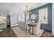 Beautiful dining room with designer lighting, board and batten accent wall, and seating for six at 827 Digby Rd, Rock Hill, SC 29730