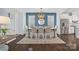 Elegant dining room with a blue accent wall, modern lighting, and seating for six at 827 Digby Rd, Rock Hill, SC 29730