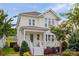 Charming two-story home with a inviting front porch, colorful landscaping, and a well-maintained lawn at 827 Digby Rd, Rock Hill, SC 29730