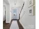 Elegant foyer with hardwood floors, staircase, modern lighting, and a view of the front door at 827 Digby Rd, Rock Hill, SC 29730