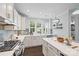 Well-lit kitchen with stainless steel appliances, a gas range, island, and gray tiled backsplash at 827 Digby Rd, Rock Hill, SC 29730