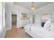 Bright primary bedroom with tray ceilings, chandelier, and ensuite bathroom with glass shower at 827 Digby Rd, Rock Hill, SC 29730