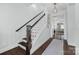 Staircase with hardwood floors, white risers, and a dark wood railing leading to the upper level at 827 Digby Rd, Rock Hill, SC 29730