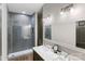 Bright bathroom with double vanity, large mirror, and glass-enclosed shower with gray subway tile at 1032 Spyglass Ln, Waxhaw, NC 28173