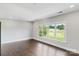 Bright bedroom featuring hardwood floors and a large window overlooking a golf course at 1032 Spyglass Ln, Waxhaw, NC 28173