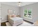 Bright bedroom with a white rug, pink bed, and a view of the front yard through the window at 1032 Spyglass Ln, Waxhaw, NC 28173