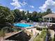 Community pool with a slide, seating, and a clubhouse for community members to enjoy at 1032 Spyglass Ln, Waxhaw, NC 28173