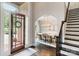 Welcoming entryway with a decorative wreath on the door and an elegant dining room beyond at 1032 Spyglass Ln, Waxhaw, NC 28173