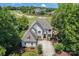 Stunning exterior elevation of home overlooking a golf course and showcases the well-maintained landscape at 1032 Spyglass Ln, Waxhaw, NC 28173