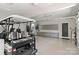 Clean and organized garage with a golf cart, epoxy floors, and custom storage cabinets at 1032 Spyglass Ln, Waxhaw, NC 28173