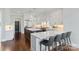 Open-concept kitchen with stainless steel appliances, an island, and seating for four at 1032 Spyglass Ln, Waxhaw, NC 28173