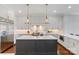 Well-appointed kitchen with a large island, breakfast bar, and stainless steel appliances at 1032 Spyglass Ln, Waxhaw, NC 28173