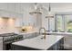 Modern kitchen featuring stainless steel appliances, a spacious island, and custom cabinetry at 1032 Spyglass Ln, Waxhaw, NC 28173