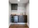 Stylish wet bar with dark cabinets, wood countertop, sink, and beverage refrigerator at 1032 Spyglass Ln, Waxhaw, NC 28173