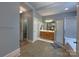 Well-lit bathroom boasts a walk-in shower, a vanity with storage, and easy access to the closet at 11646 Hidden Forest Ln, Davidson, NC 28036