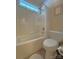 A full bathroom with a shower over tub, toilet, small window and tile flooring at 11646 Hidden Forest Ln, Davidson, NC 28036