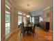 Well lit dining area features a round wooden table set with four chairs and windows on two walls at 11646 Hidden Forest Ln, Davidson, NC 28036