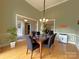 Dining room showcases hardwood floors, an elegant chandelier, and seamless flow into the living spaces at 11646 Hidden Forest Ln, Davidson, NC 28036