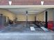 Spacious garage with a car lift, offering ample room for vehicle storage and workshop space at 11646 Hidden Forest Ln, Davidson, NC 28036