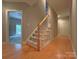 Hallway with hardwood floors, a staircase with carpeted steps, and doorways leading to other rooms at 11646 Hidden Forest Ln, Davidson, NC 28036