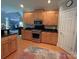 Well-equipped kitchen features stainless steel appliances, wooden cabinets, and dark countertops at 11646 Hidden Forest Ln, Davidson, NC 28036