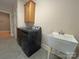 Laundry room equipped with a modern washer and dryer, utility sink, and storage cabinet, offering convenience at 11646 Hidden Forest Ln, Davidson, NC 28036