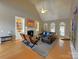 Bright and airy living room with a fireplace, custom shelving, and large windows for natural light at 11646 Hidden Forest Ln, Davidson, NC 28036